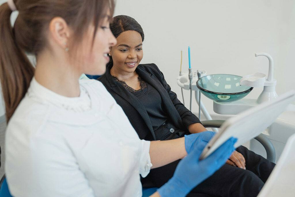 Patient asking dentist about dental cleaning costs