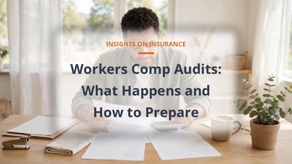 Workers comp audit - small business owner reviewing payroll documents at desk